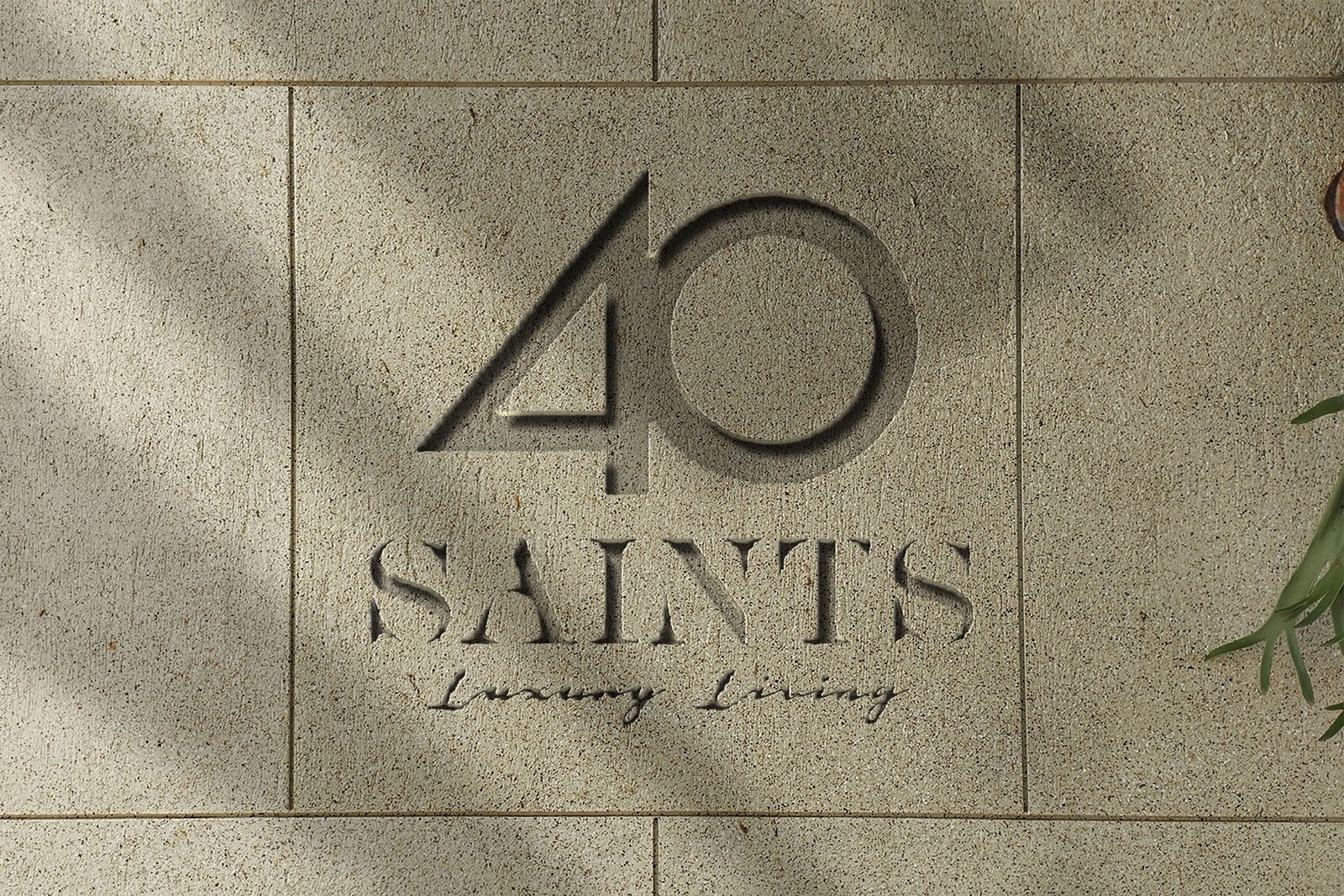 Taş yüzeye oyulmuş 40 Saints Luxury Living logosu