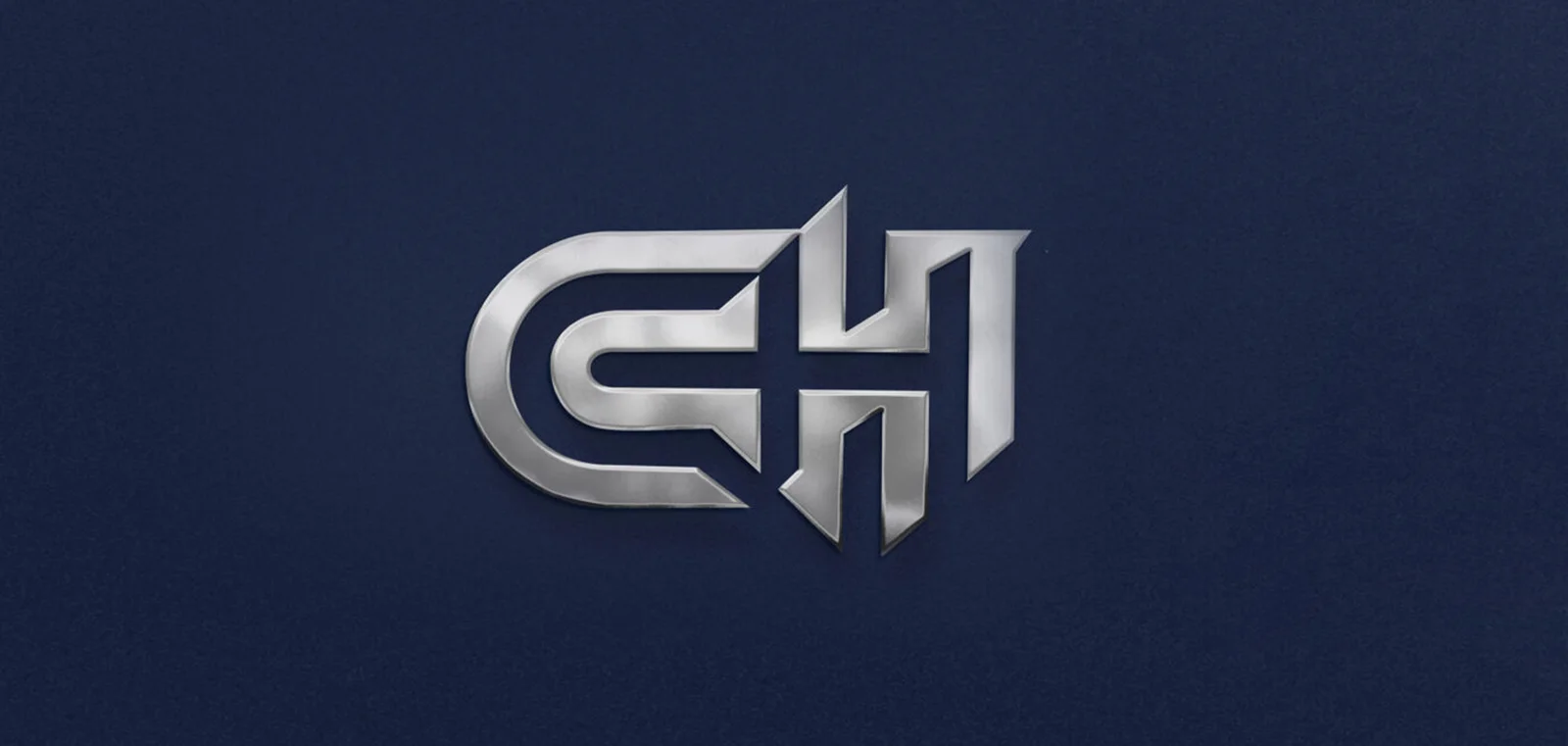 A polished metal CH monogram embossed on a textured navy ground