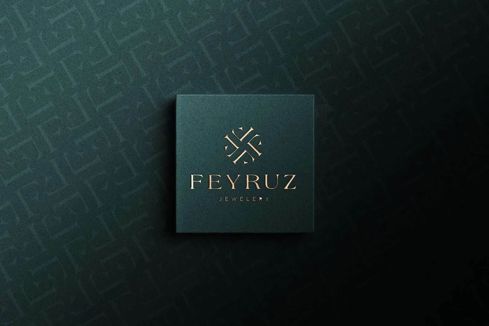 The Feyruz Jewelery logo embossed in copper on a dark teal card, with a letter pattern behind it