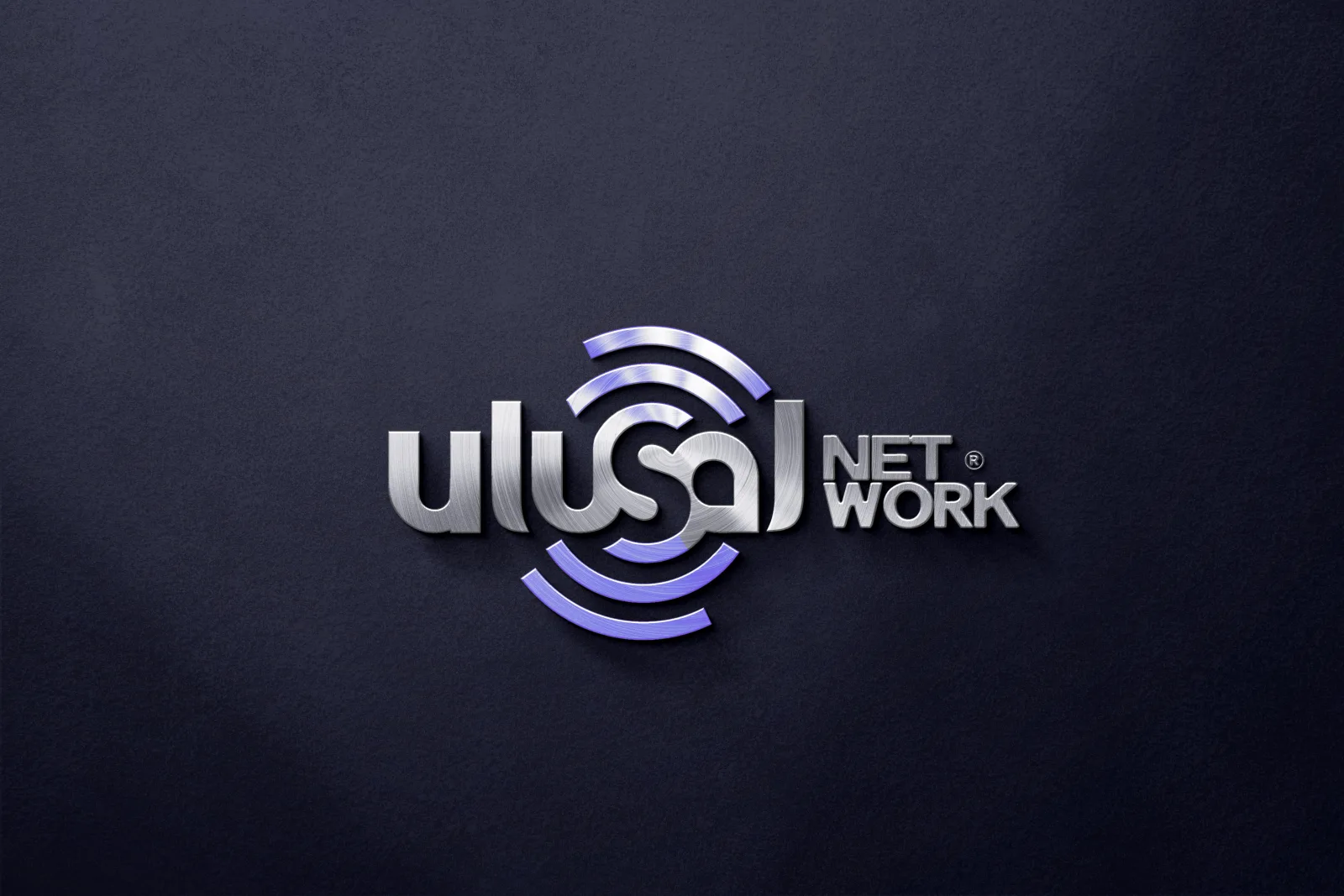 The Ulusal Network logo in three dimensions, brushed metal letters and purple signal rings on a dark navy ground